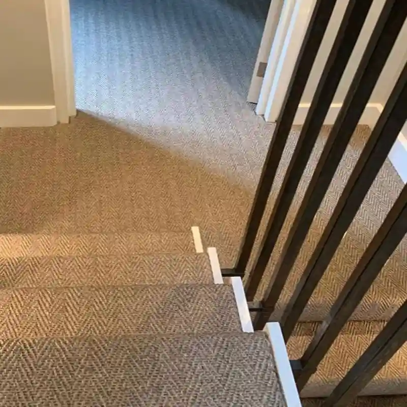 Chevron-patterned sisal carpet installed as a stair runner