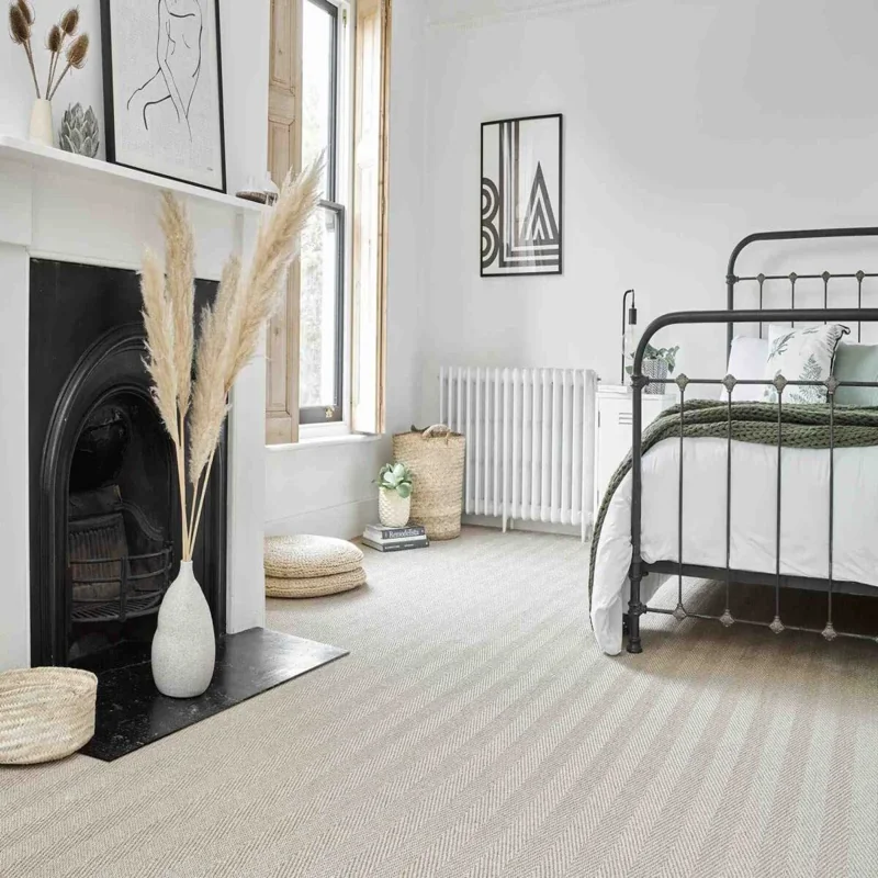 Light-colored sisal carpet with a chevron weave pattern